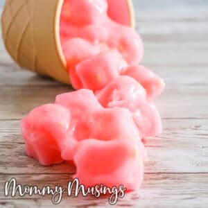 DIY Pink Lemonade Jelly Cube Slime spilling out of a cup onto the table