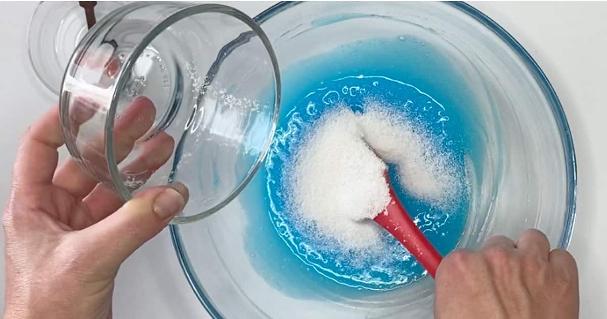 adding fake snow to make blue raspberry icee slime