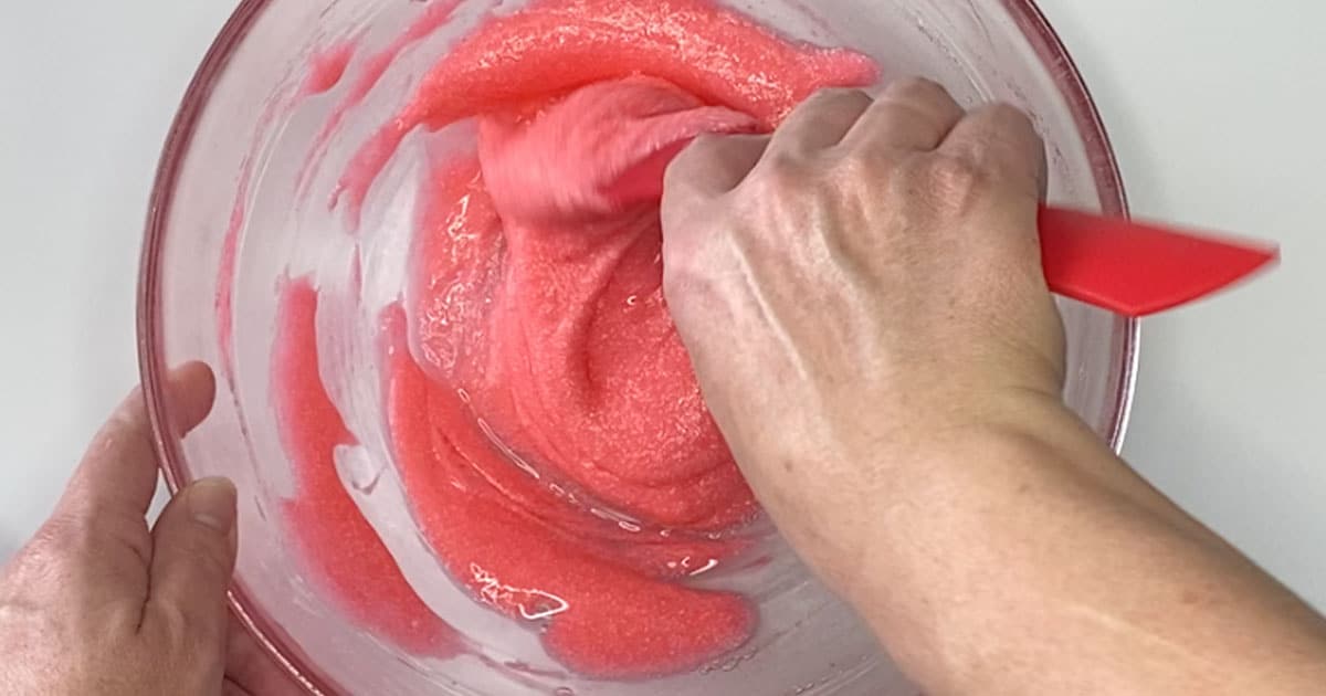 in-process step of stirring together ingredients to make cherry icee slime