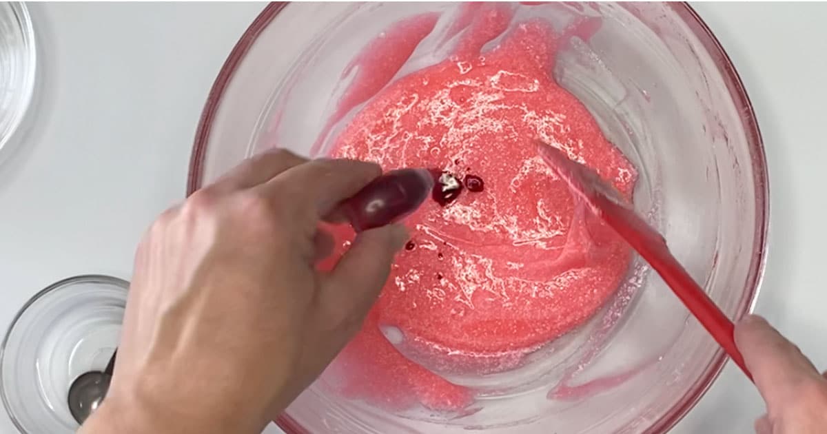 adding food coloring to make cherry icee slime