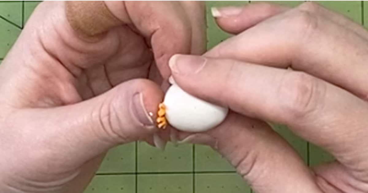 adding chicken feet to a polymer clay egg charm