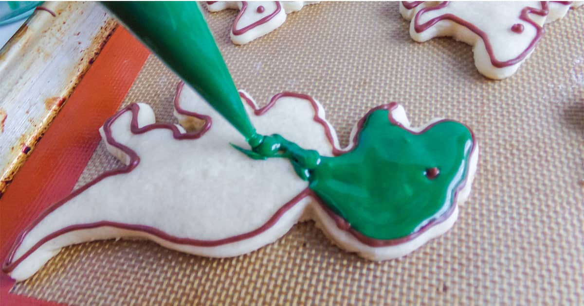 how to decorate cut-out cookies in a dinosaur shape