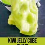 kiwi slime spilling onto a table with text which reads kiwi jelly cube slime