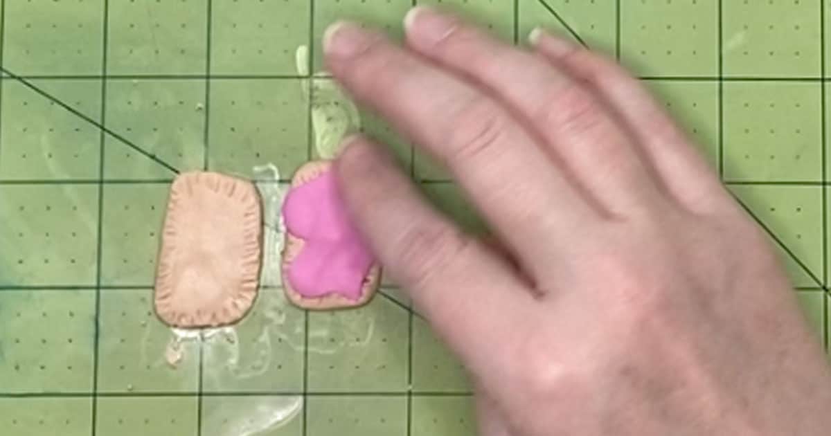 in-process step of putting icing onto polymer clay pop tart charms