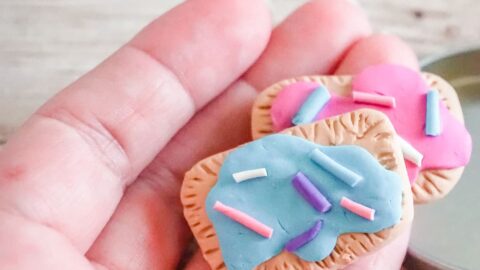 polymer clay pop tart charms being held in a hand