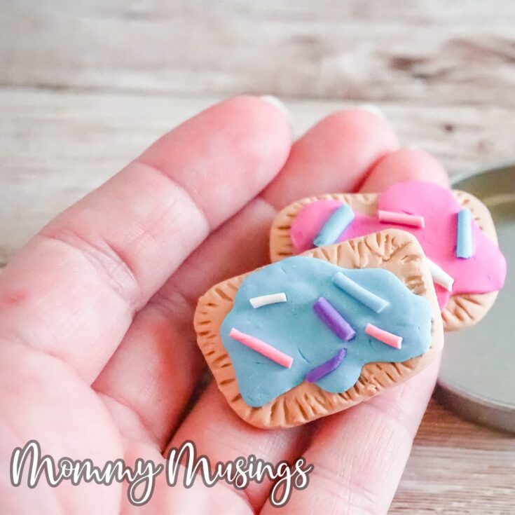 polymer clay pop tart charms being held in a hand