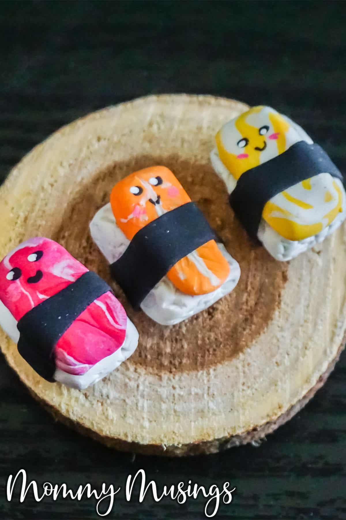 polymer clay sushi charms on a wood plate