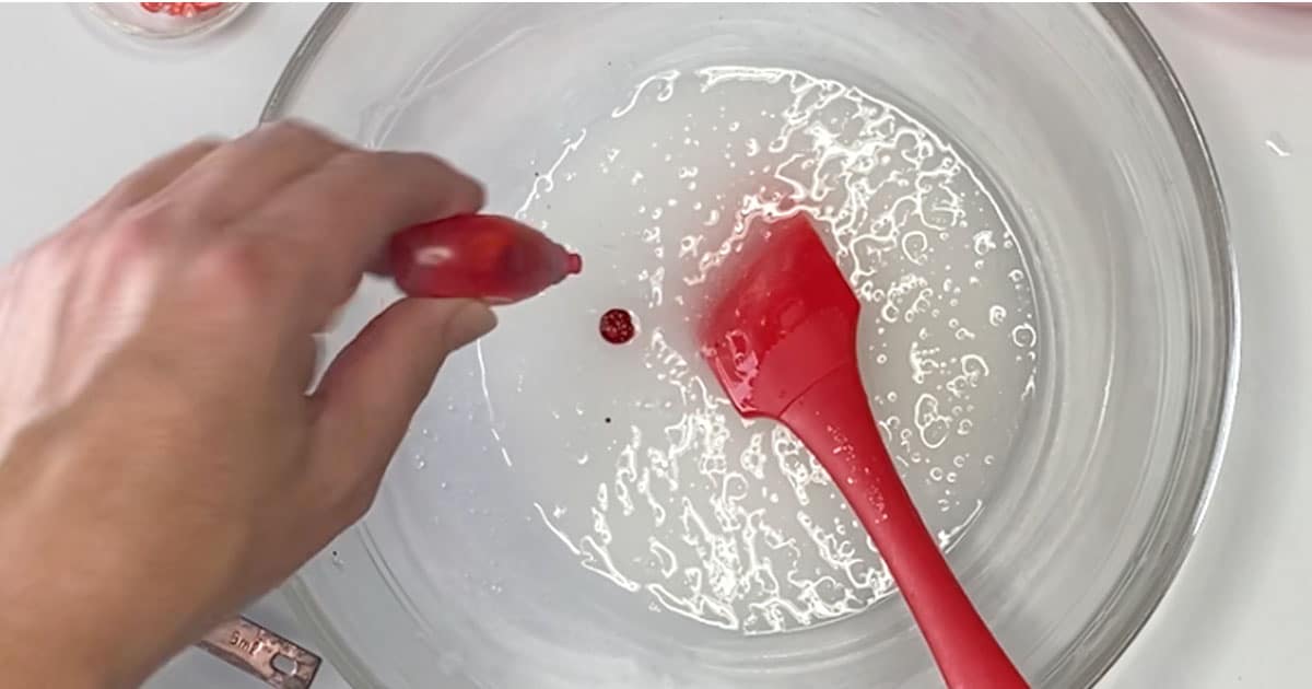 food coloring being added to ingredients to make strawberry jelly cube slime